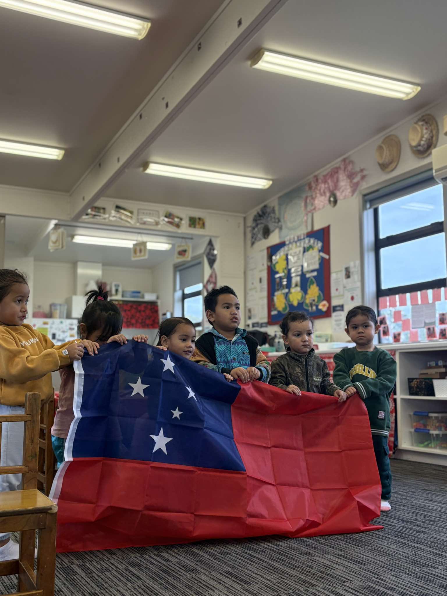 Tamariki holding the Samoan flag